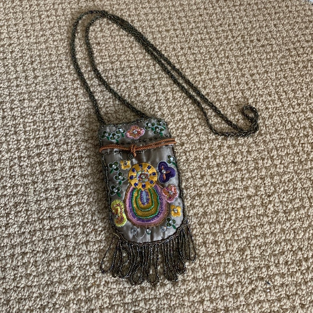Mini embroidered and beaded with beads and sequins.